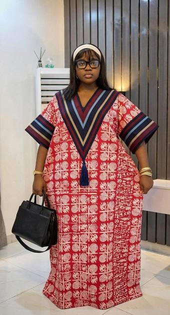 Red adire kaftan with striped neckline and tassel