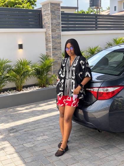 Black batik shirt and red shorts worn outdoors