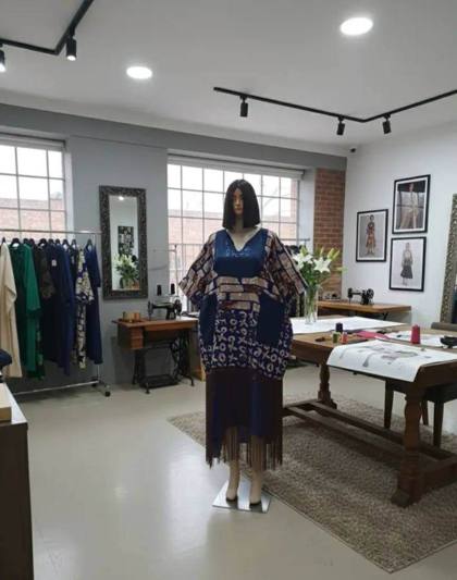 Blue batik top with fringe in the atelier