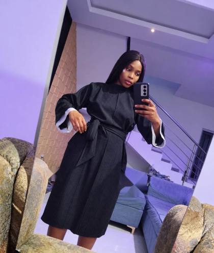 Black pinstripe belted dress worn