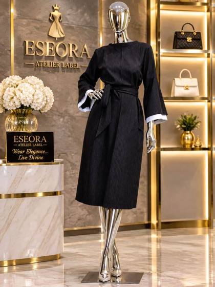 Black pinstripe belted dress with flared sleeves on a mannequin